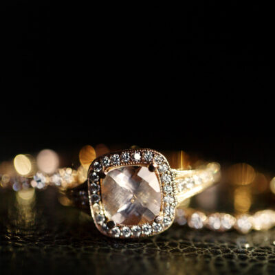 Jewels sparkle in the golden wedding rings lying on the leather