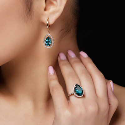 Model shows earrings and ring with beautiful blue precious stones